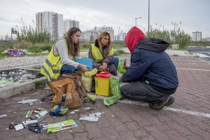 Portugal, Lisbon. 2016-12-07. Social  workers Andreia Alves and Rita Lopes collect waste such as syringes and distribute a new health kit with syringes and other material to a drug addict in the neighbourhood of Lumiar.