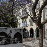 Portugal, Lisbon, Chiado, Largo do Carmo. 2014. A street photo exhibition commemorates the successful 25 of April 1974 rebellion against the dictatorship. The photo panel shows Captain Salgueiro Maia in an armoured vehicle at the exact same location negotiating the surrender of the Caetano government which had taken refuge in the barracks visible in the background.