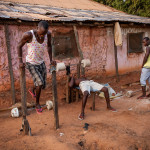 Guinea-Bissau, Cacheu. 2013. Young men work out at their improvised gym.