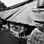 Guinea-Bissau, Ingoré. 2005. A woman carries her trade on the market.