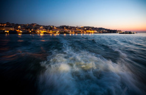 Portugal, Lisbon, River Tagus. 2011. The city of Lisbon at sunrise as viewed from the stern of the ferry boat en route to Cacilhas on the southern bank.