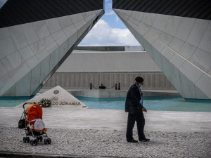 Portugal, Lisbon. 2008. A war veteran walks in front of the Colonial War Memorial in Belém in Lisbon. All the names of the fallen soldiers are engraved on the wall.