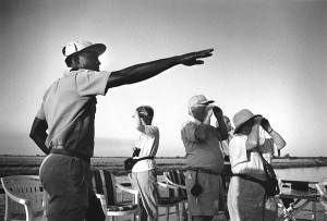 Botswana, Chobe river. 1992. A local guide tells American tourists about Africa's wildlife.