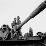 Eritrea, near Asmara. 1995. Children use an scrap army tank as a playground. Hundreds of tanks and trucks are piled up near the capital. A reminder of the bloody 30 year long (1961-1991) independence war with Ethiopia. 65.000 people lost their lives.