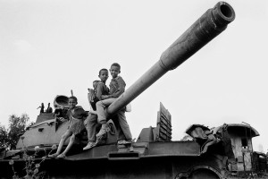 Eritrea, near Asmara. 1995. Children use an scrap army tank as a playground. Hundreds of tanks and trucks are piled up near the capital. A reminder of the bloody 30 year long (1961-1991) independence war with Ethiopia. 65.000 people lost their lives.