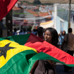 Portugal, Amadora, Alto Cova da Moura. 2010. Whassysa Magelhães carries the national flag of her native São Tomé e Príncipe at the Cape Verdian 'Festa de Kola San Jon', the celebration of the Day of Saint John (Summer Solstice).