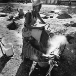 Guinea-Bissau, K3 village, on the outer marshes of the River Cacheu. 2005. A woman filters silt to extract the salt.