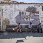 Portugal, Alentejo, Almodôvar. A village with a fast ageing population while a poster announces ambitious renovation plans including some cool youngsters.