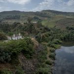 Portugal, Alto Douro, Abreiro. 2017. The closed railway station and bridge of Abreiro along the River Tua.