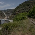 Portugal, Alto Douro, near the village of Tua. 2017. Part of the abandoned Tua railway line next to the completed Foz Tua Dam. Its storage reservoir is submerging a bigger part of this historic railroad that was built in 1887.